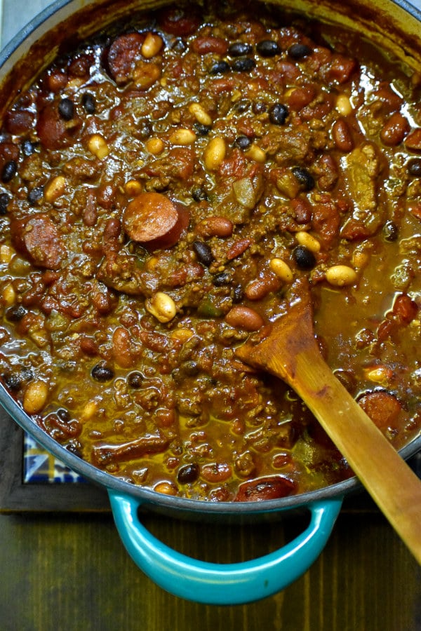 ultimate chili in a dutch oven with a wooden spoon