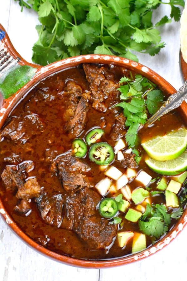 Beef Birria is an amazingly flavorful Mexican stew with a rich chili pepper infused consommé. Just wait till you try the meat in tacos...