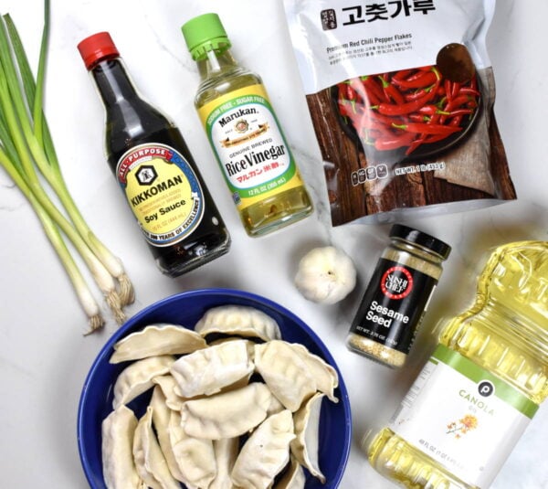 Spicy dumpling ingredients arranged on a white background.