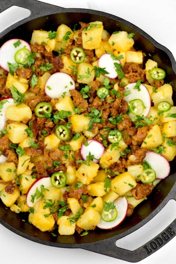 papas con chorizo in a cast iron skillet