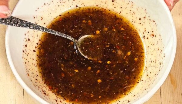 Dressing for balela salad in a small bowl.