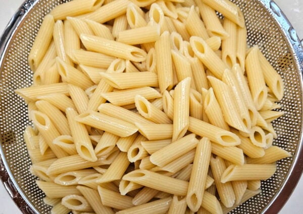 Boiled pasta in a colander.