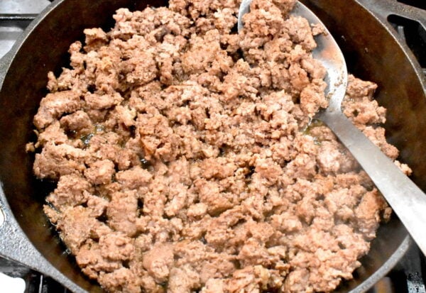 Browned ground beef in a skillet.