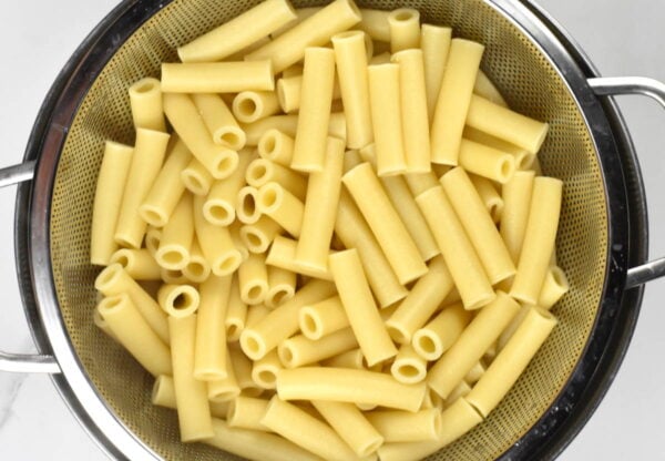 Cooked pasta in a colander.