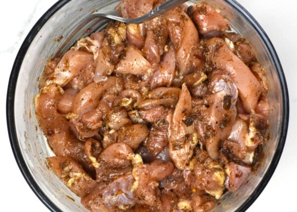 Marinating the chicken.