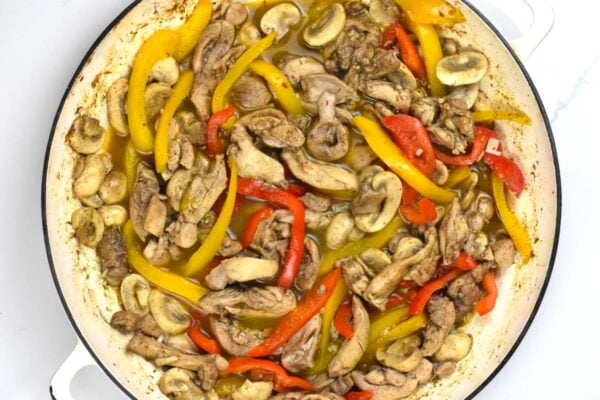Adding peppers and mushrooms.