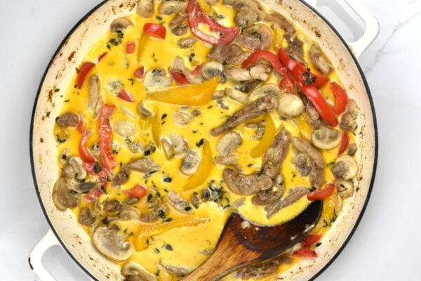 Mixing in the cream and cheese.