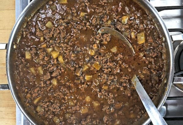 Ground beef and vegetables simmering in a brown gravy.