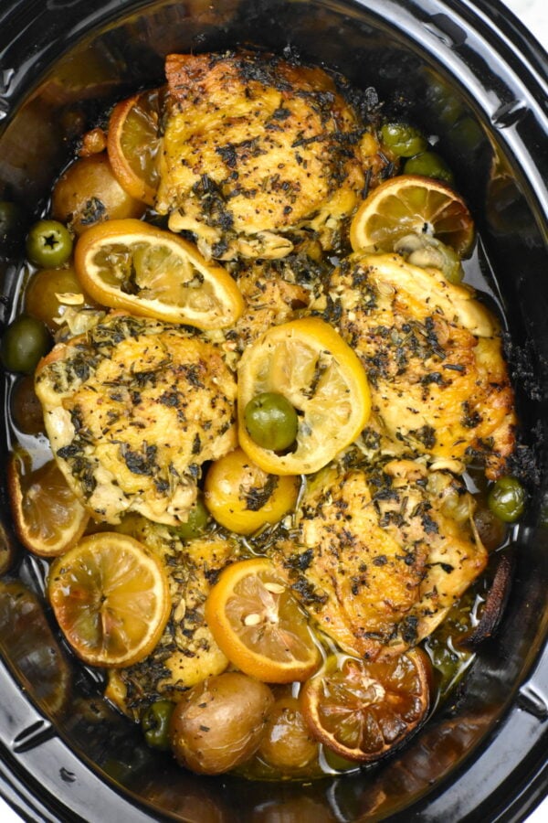 Crockpot chicken thighs with potatoes and herbs.