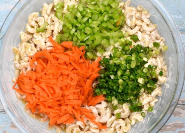 Adding veggies into salad.