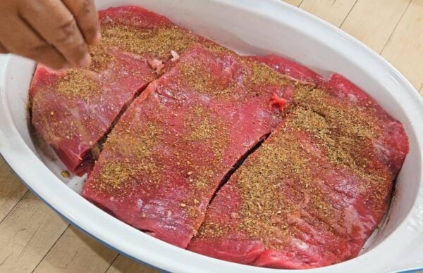 Seasoning the flank steak.