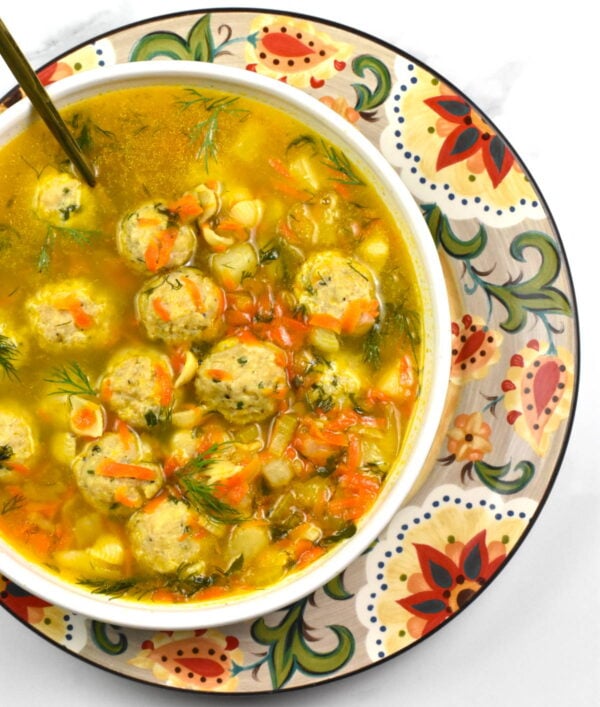 Bowl of frikadelki soup atop the Gypsy Plate.