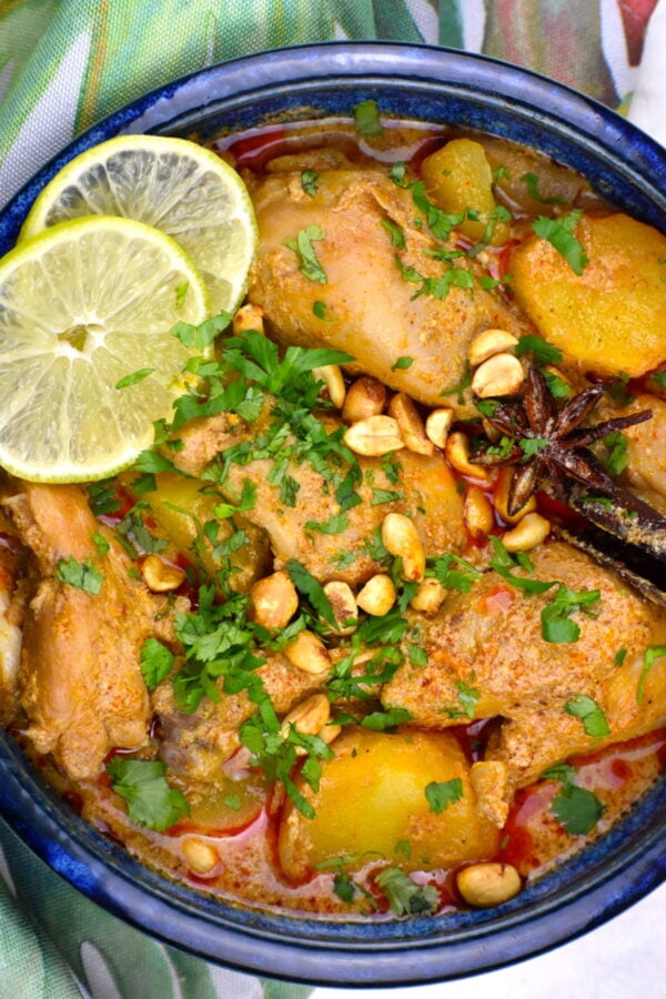 Chicken massaman curry in a blue bowl.