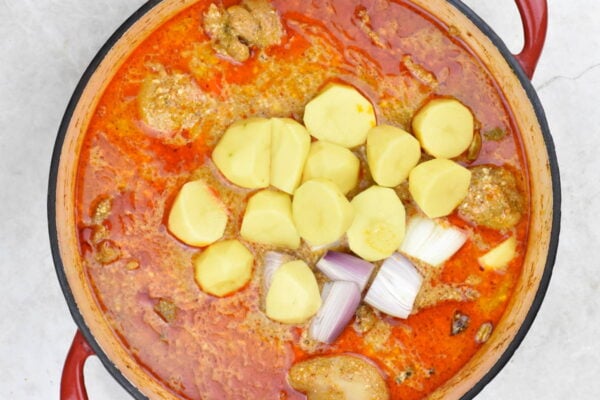 Potatoes and shallot added to the curry.