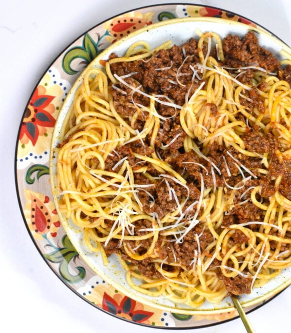 Bowl of greek spaghetti atop the Gypsy Plate.