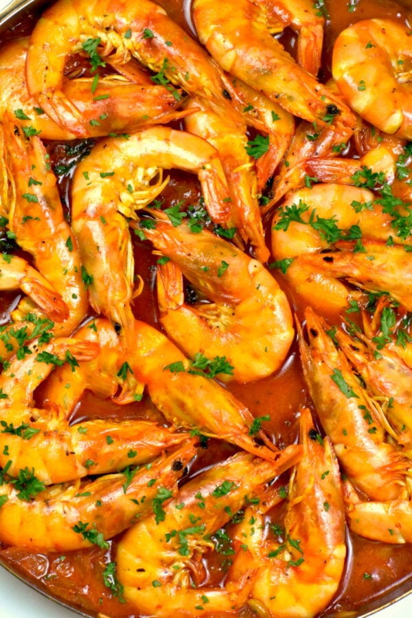 Close up of head on shrimp in a spicy sauce.