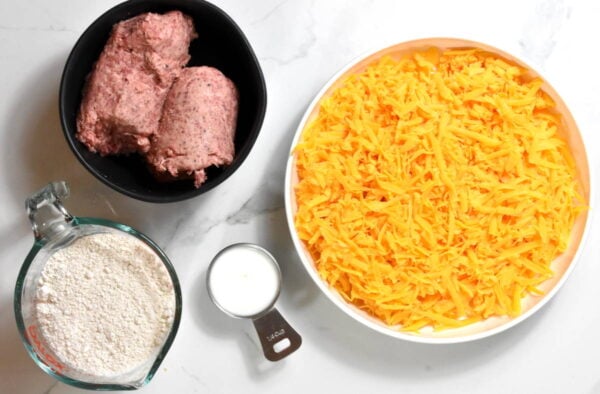 Sausage, cheese, bisquick and milk on a white background.