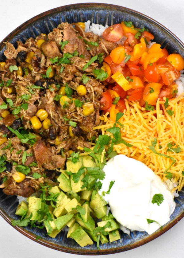 slow cooker southwest chicken in a bowl with toppings