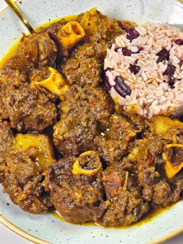 curry goat served with rice and peas