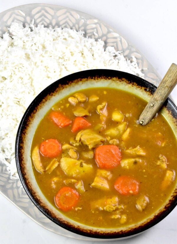 bowl of curry on a platter of rice