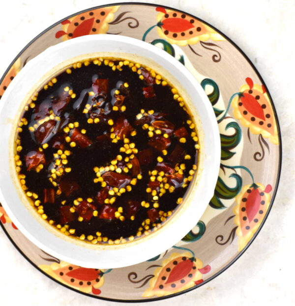 bowl of kung pao sauce atop the gypsy plate