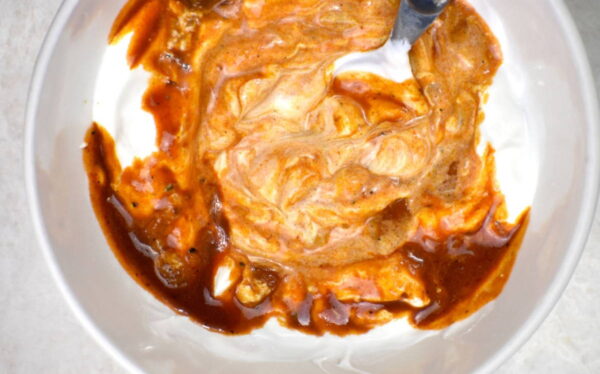 stirring a little of the paprikash sauce into the sour cream