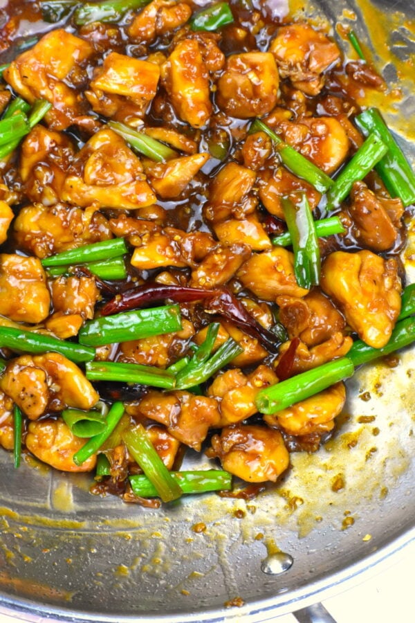 chicken cooking with sauce in a wok