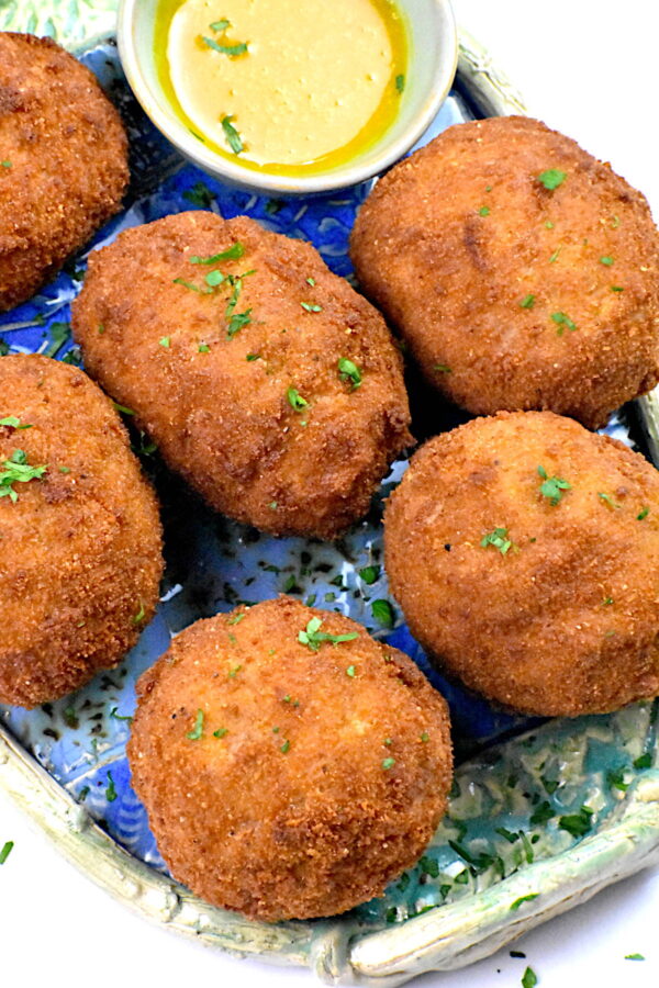 a half dozen scotch eggs on a platter