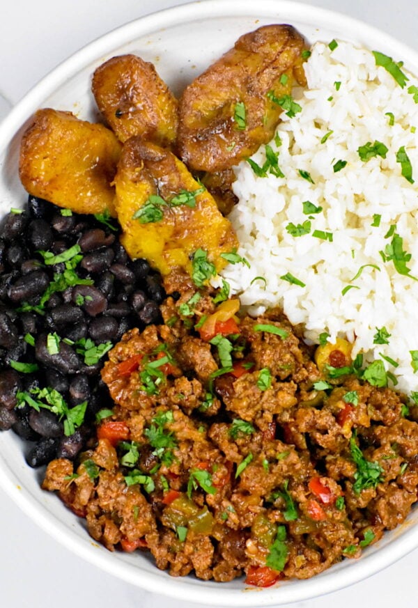 picadillo in a bowl with rice and black beans