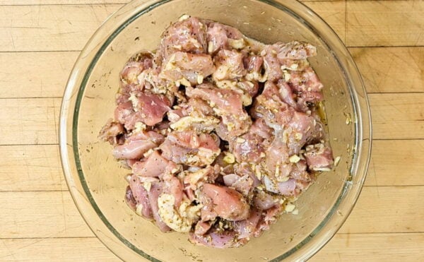 chicken marinating in a bowl