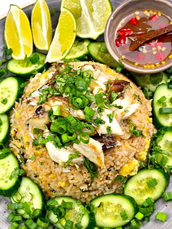 thai crab fried rice on a plate with garnishes