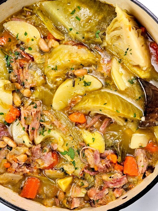 Pot full of ham, bean and vegetable soup.