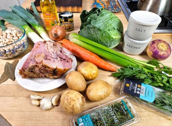 Garbure recipe ingredients arranged on a counter.