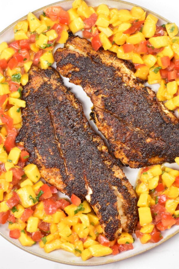 Blackened redfish on a bed of mango salsa.