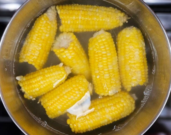 Boiling corn on the cobb.