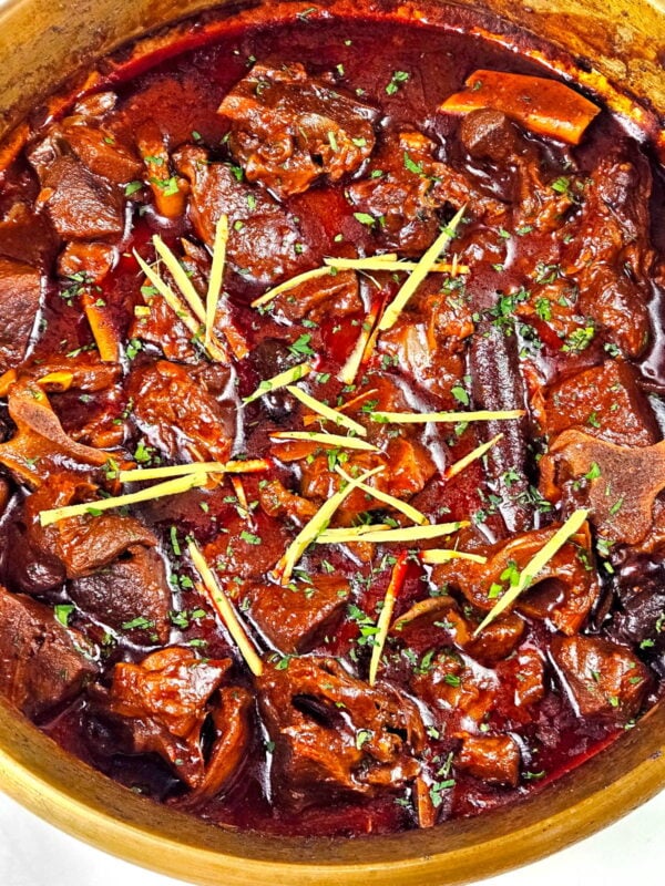 Rogan josh garnished with ginger and cilantro.