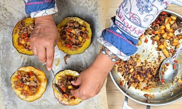 Filling the squash halves with sausage stuffing.