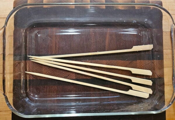Soaking wooden skewers in water.