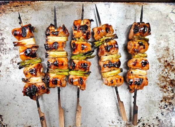 Finished yakitori skewers on a baking sheet.