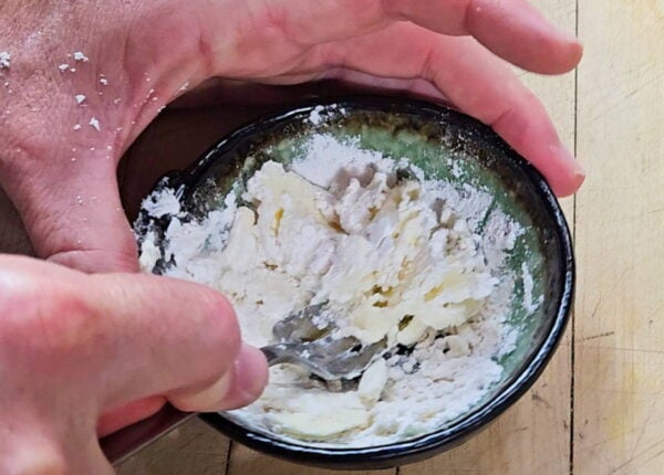 Mixing flour into softened butter.